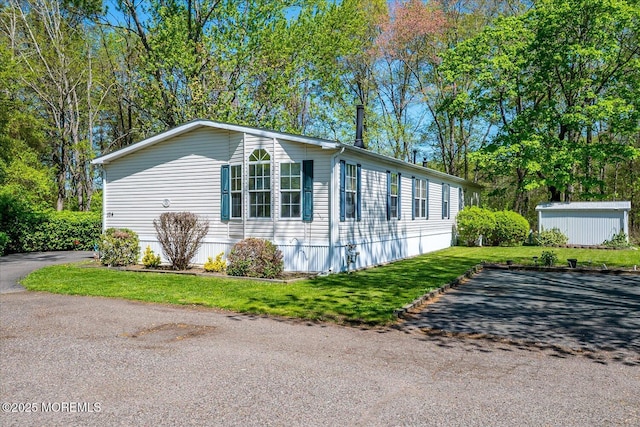 104 Village Rd, Morganville, NJ 07751 - view of side of property featuring a lawn and an outdoor structure