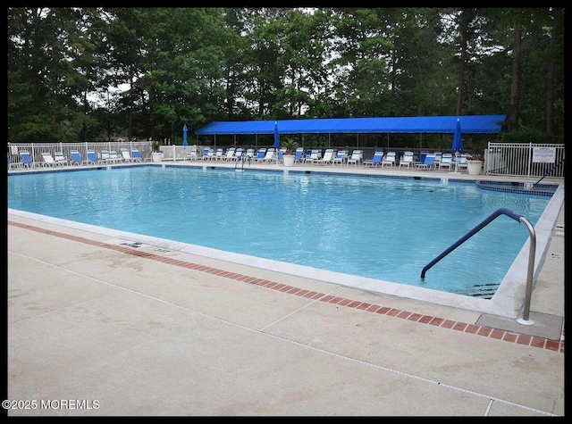 2271 Kira Ct, Toms River, NJ 08755 - community pool with fence, view of scattered trees, and a patio