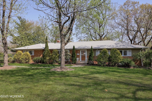 single story home featuring brick siding and a front lawn