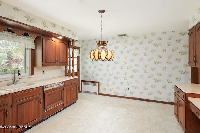 kitchen with a sink, radiator, wallpapered walls, and dishwasher