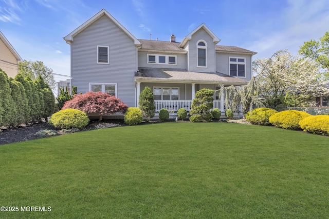 14 Dolan Ave, Aberdeen, NJ 07747 - rear view of property featuring a porch, a lawn, and a chimney