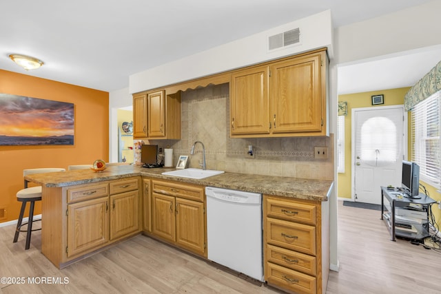 14 Dolan Ave, Aberdeen, NJ 07747 - kitchen with a sink, white dishwasher, light wood finished floors, and visible vents
