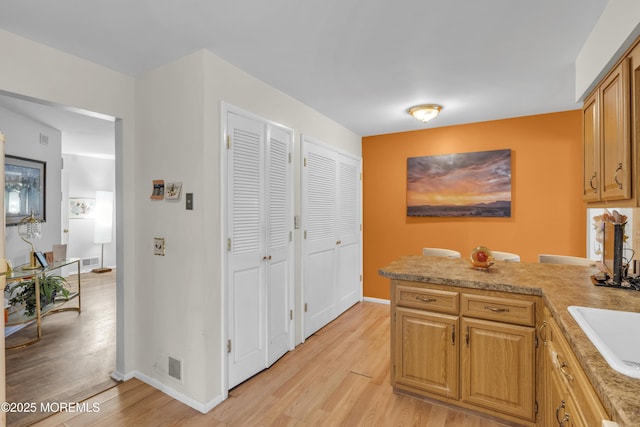 14 Dolan Ave, Aberdeen, NJ 07747 - kitchen with light wood-style floors, light countertops, baseboards, and a peninsula
