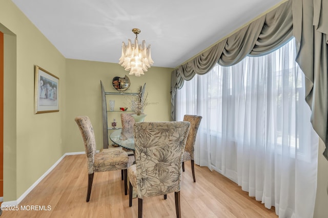 14 Dolan Ave, Aberdeen, NJ 07747 - dining area with a chandelier, a healthy amount of sunlight, and light wood-style floors