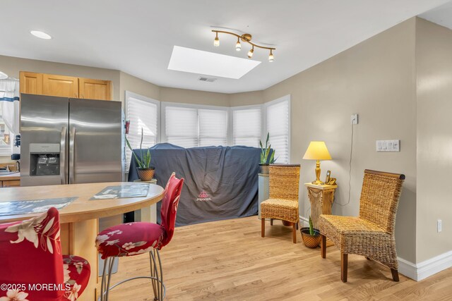 14 Dolan Ave, Aberdeen, NJ 07747 - kitchen featuring a skylight, baseboards, plenty of natural light, and light wood-style floors