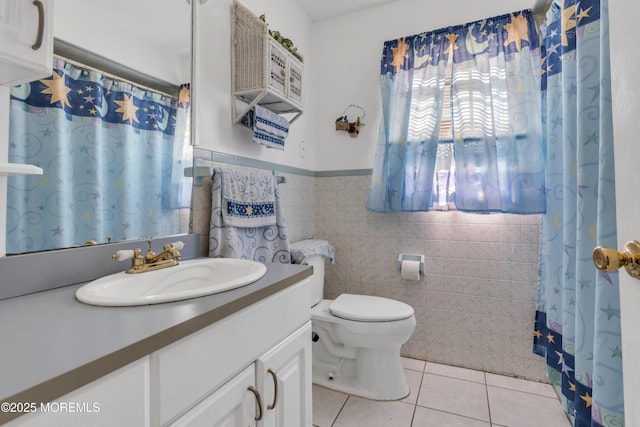 14 Dolan Ave, Aberdeen, NJ 07747 - bathroom featuring vanity, wainscoting, toilet, tile walls, and tile patterned floors