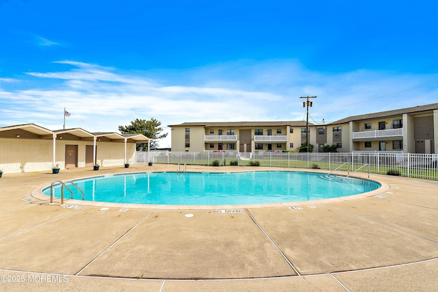 pool with fence and a patio