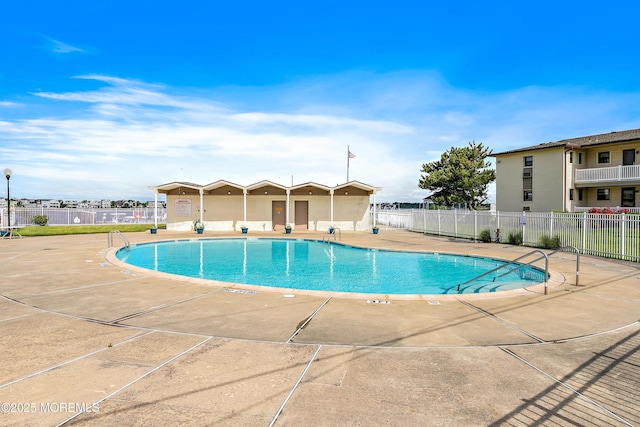 pool featuring a patio area and fence