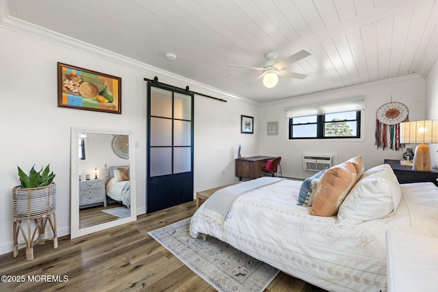 bedroom with a barn door, wood finished floors, wooden ceiling, an AC wall unit, and ornamental molding