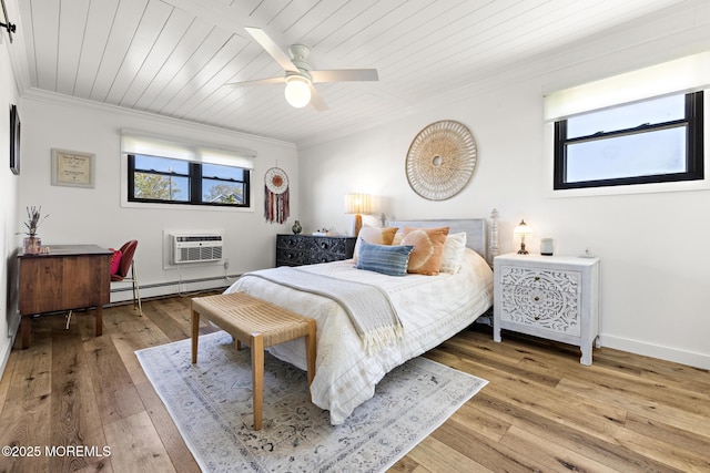 bedroom with crown molding, a baseboard heating unit, multiple windows, and a wall mounted air conditioner