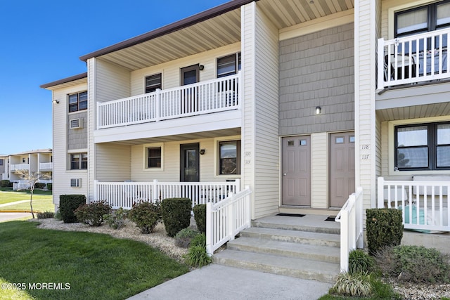 view of front of house with a balcony and covered porch