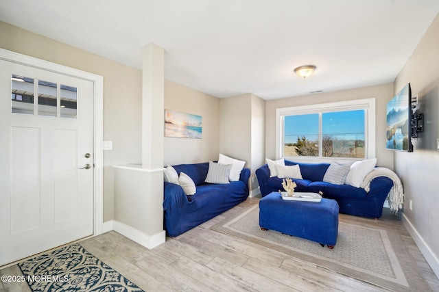 living room featuring baseboards and wood finished floors