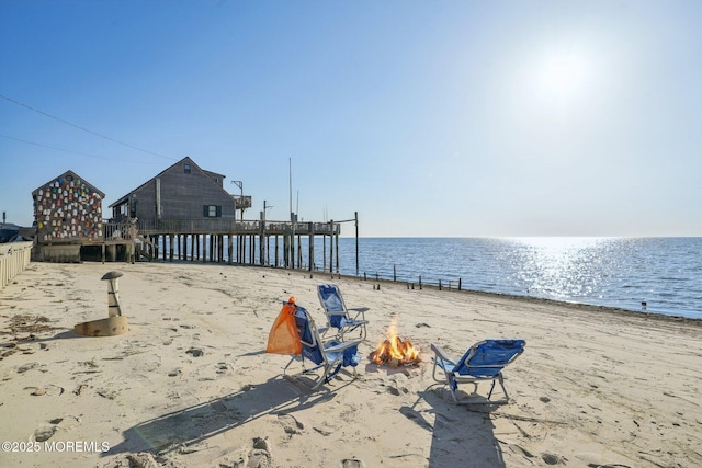water view with a view of the beach and a fire pit