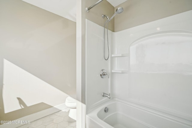 full bathroom with toilet, tile patterned floors, and tub / shower combination