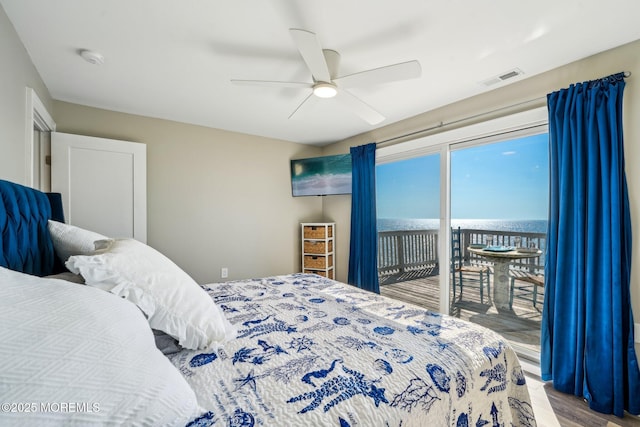 bedroom featuring access to outside, a ceiling fan, wood finished floors, and visible vents