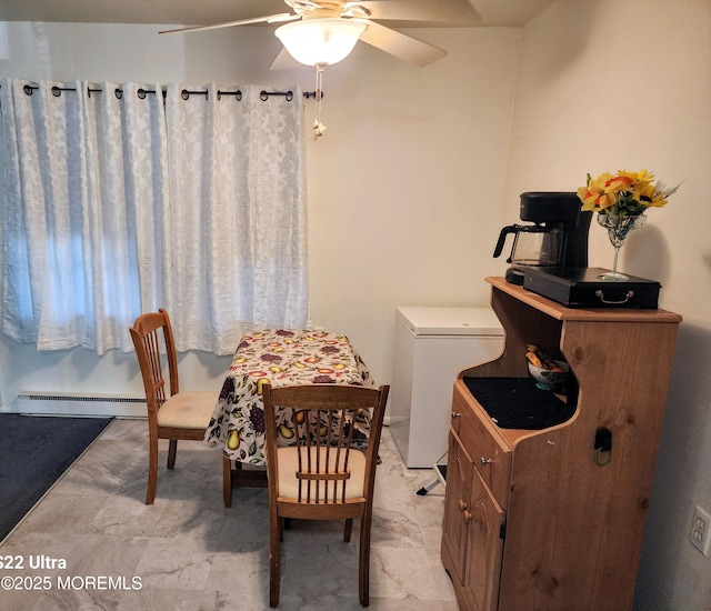 dining room with a ceiling fan and a baseboard heating unit