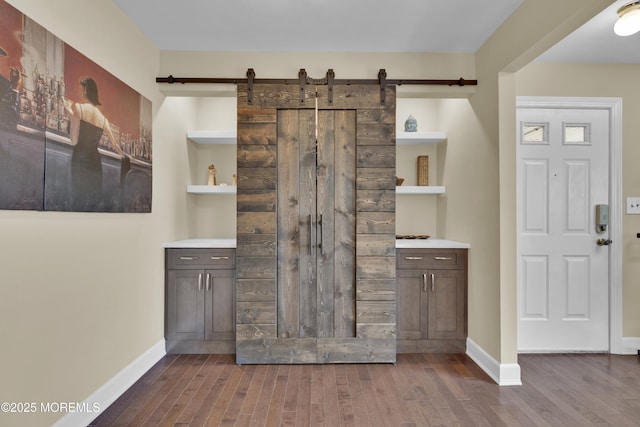 1606 Main St Unit R305, Belmar, NJ 07719 - interior space featuring baseboards, a barn door, and wood finished floors
