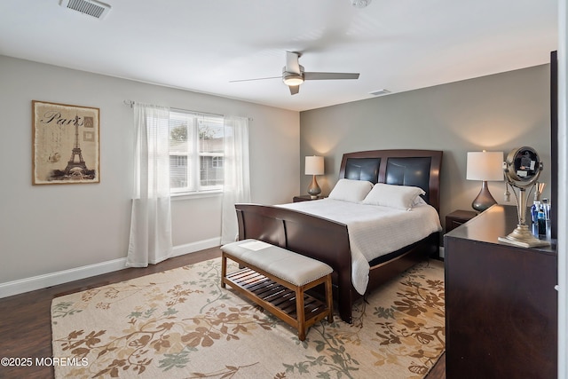 bedroom featuring baseboards, a ceiling fan, wood finished floors, and visible vents
