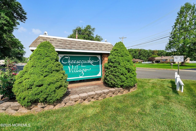 community / neighborhood sign featuring a yard