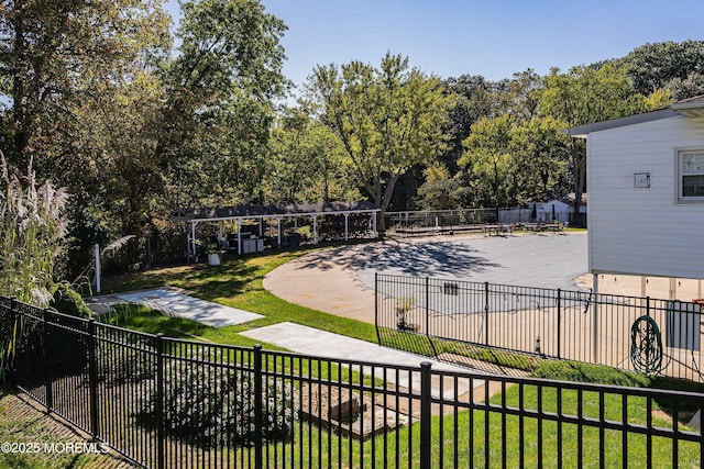 view of community with a yard and fence