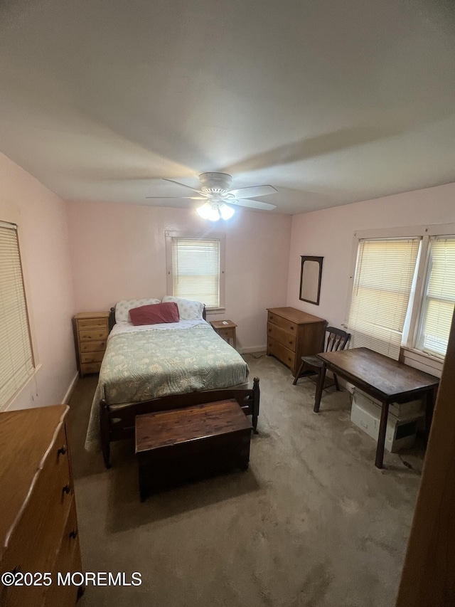 bedroom with carpet floors, baseboards, and a ceiling fan