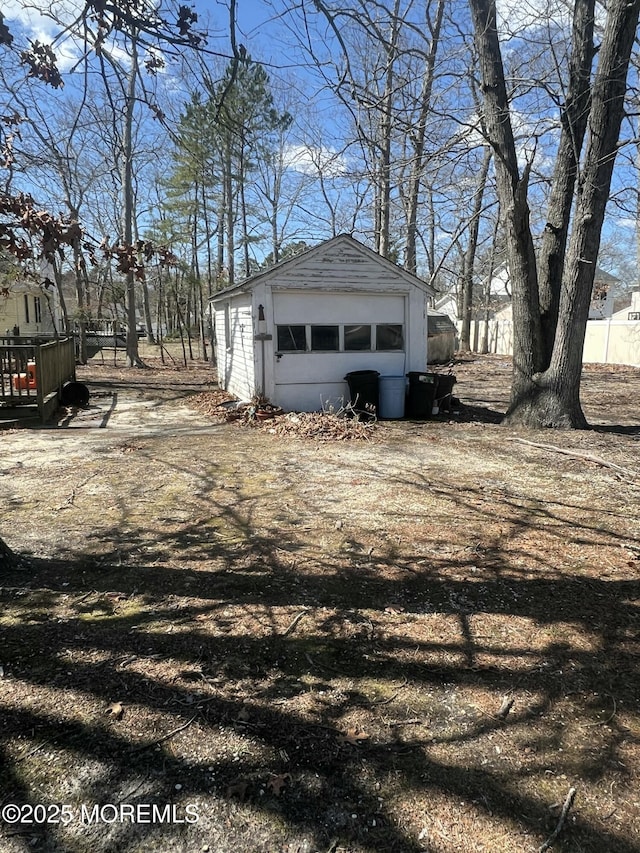 exterior space featuring a garage and an outbuilding