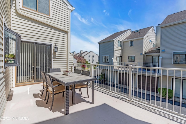balcony with a residential view and outdoor dining space