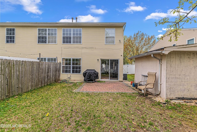 back of property featuring a patio, a fenced backyard, and a yard