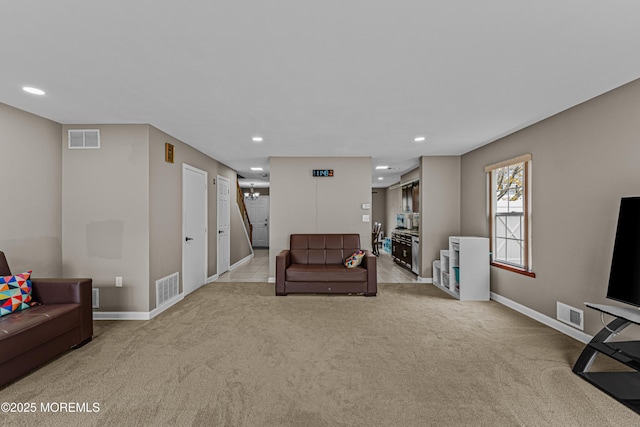 sitting room featuring visible vents, recessed lighting, and light colored carpet