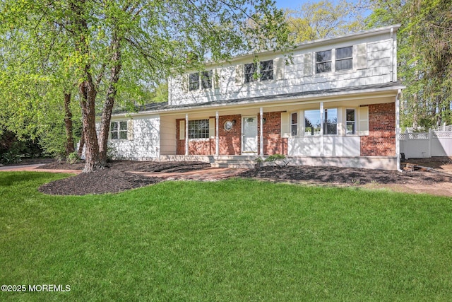 2338 Ramshorn Dr, Allenwood, NJ 08720 - view of front of house featuring a porch, fence, a front yard, and brick siding