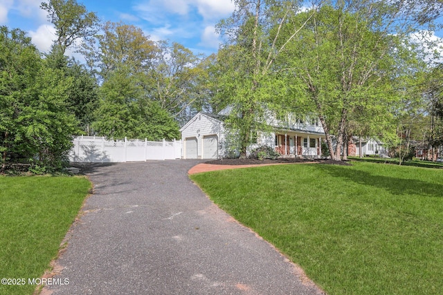 2338 Ramshorn Dr, Allenwood, NJ 08720 - view of front of home with a garage, aphalt driveway, fence, a front yard, and a porch