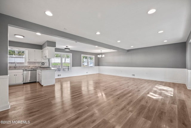 2338 Ramshorn Dr, Allenwood, NJ 08720 - unfurnished living room with recessed lighting, a sink, wood finished floors, and a notable chandelier