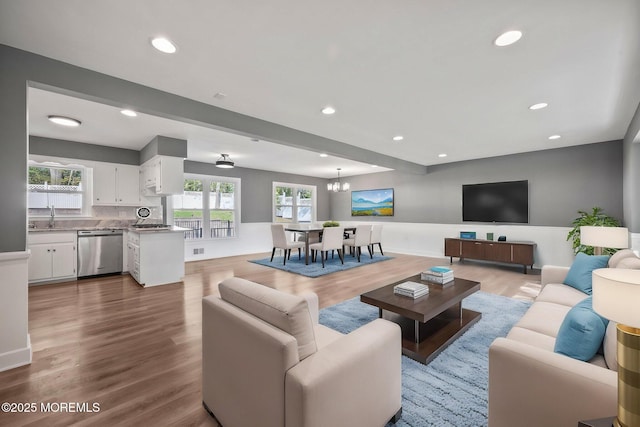 2338 Ramshorn Dr, Allenwood, NJ 08720 - living area with recessed lighting, wood finished floors, visible vents, and an inviting chandelier