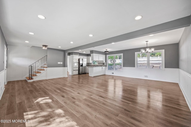 2338 Ramshorn Dr, Allenwood, NJ 08720 - unfurnished living room with recessed lighting, stairs, light wood-style floors, and a wainscoted wall