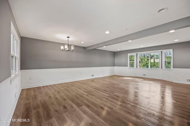 2338 Ramshorn Dr, Allenwood, NJ 08720 - spare room with wainscoting, wood finished floors, beamed ceiling, an inviting chandelier, and recessed lighting