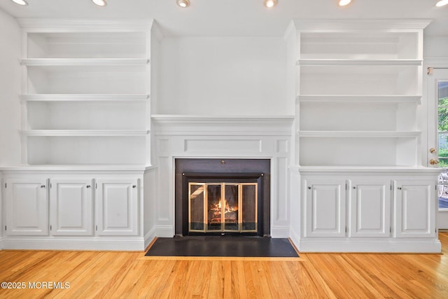 2338 Ramshorn Dr, Allenwood, NJ 08720 - unfurnished living room featuring recessed lighting, a fireplace with flush hearth, light wood-style flooring, and built in shelves