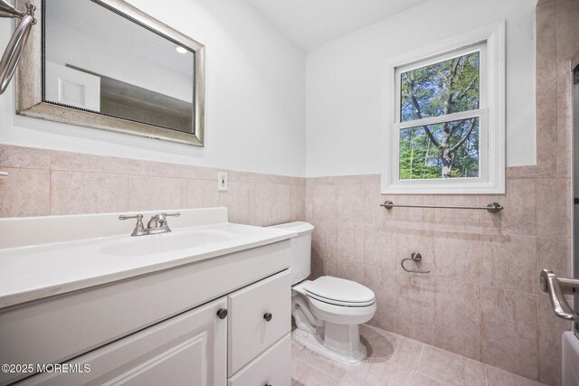 2338 Ramshorn Dr, Allenwood, NJ 08720 - bathroom featuring vanity, a wainscoted wall, toilet, and tile walls