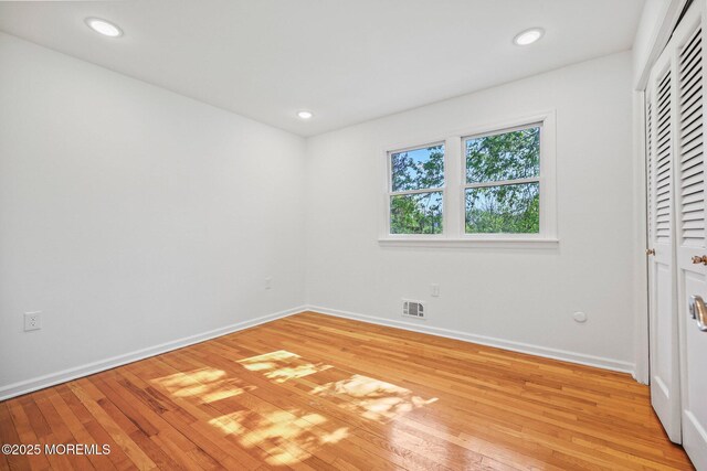 2338 Ramshorn Dr, Allenwood, NJ 08720 - unfurnished bedroom with visible vents, a closet, light wood-style floors, baseboards, and recessed lighting