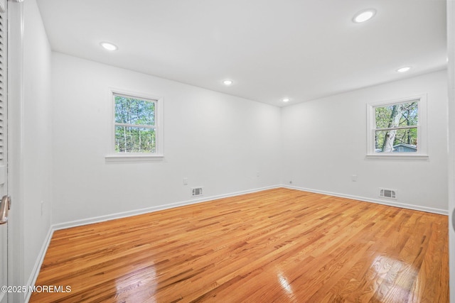 2338 Ramshorn Dr, Allenwood, NJ 08720 - empty room featuring baseboards, visible vents, a healthy amount of sunlight, and light wood-type flooring