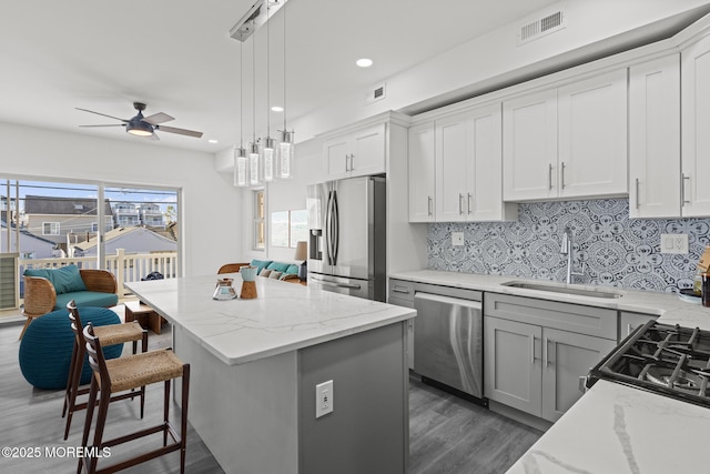 1501 Central, Seaside Heights, NJ 08751 - kitchen with appliances with stainless steel finishes, a sink, a kitchen island, dark wood-style flooring, and ceiling fan