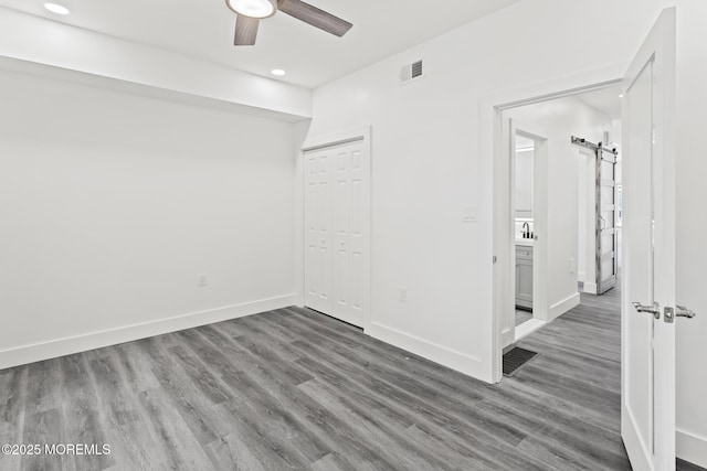 1501 Central, Seaside Heights, NJ 08751 - unfurnished bedroom featuring wood finished floors, a barn door, baseboards, a closet, and recessed lighting