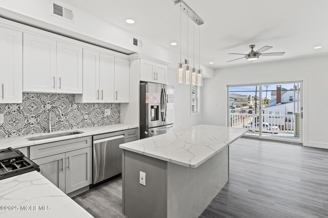 1501 Central, Seaside Heights, NJ 08751 - kitchen featuring stainless steel appliances, a sink, ceiling fan, decorative backsplash, and light wood-style flooring