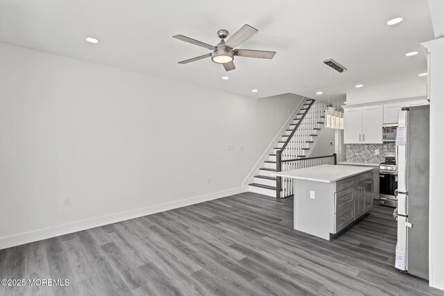 1501 Central, Seaside Heights, NJ 08751 - kitchen featuring stainless steel appliances, light countertops, ceiling fan, a center island, and dark wood-type flooring