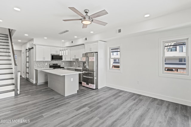1501 Central, Seaside Heights, NJ 08751 - kitchen featuring appliances with stainless steel finishes, a center island, light countertops, backsplash, and a ceiling fan