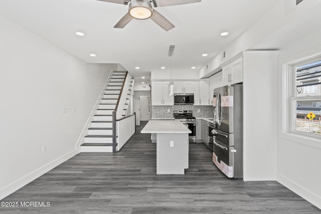 1501 Central, Seaside Heights, NJ 08751 - kitchen with appliances with stainless steel finishes, a center island, light countertops, white cabinetry, and a ceiling fan