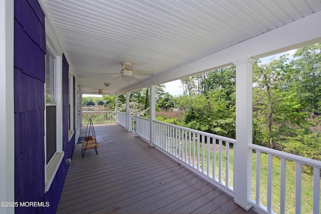 wooden deck featuring a ceiling fan and covered porch