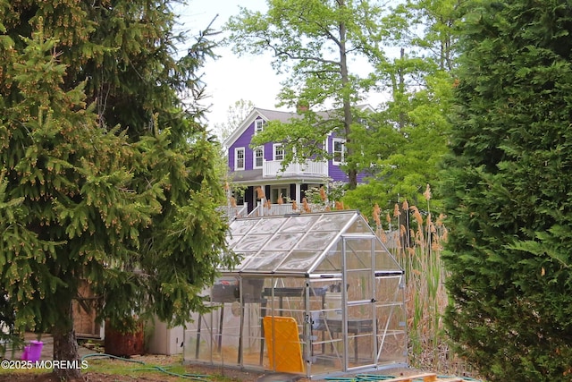 rear view of house with an exterior structure and an outbuilding