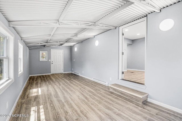 interior space with a healthy amount of sunlight, baseboards, and wood finished floors