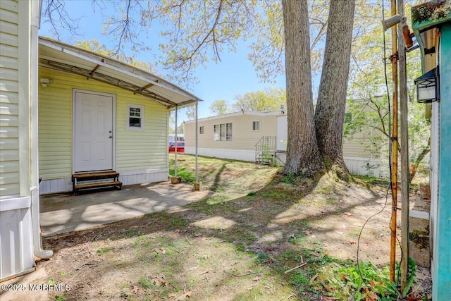 view of yard with entry steps and a patio area