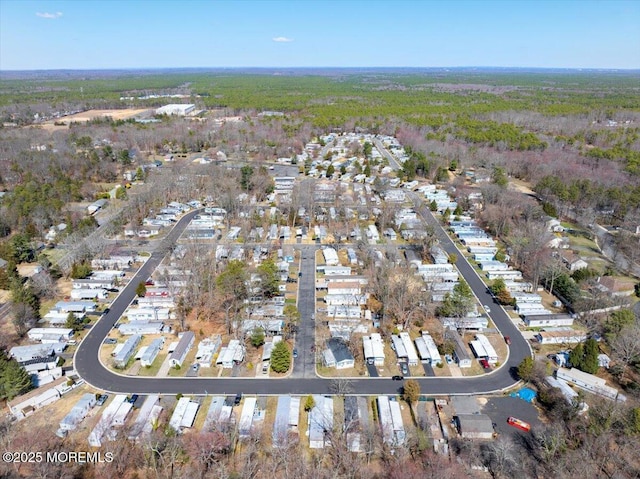 drone / aerial view featuring a forest view
